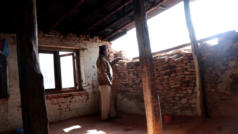 Madan Shakya explaining the damage to his house.