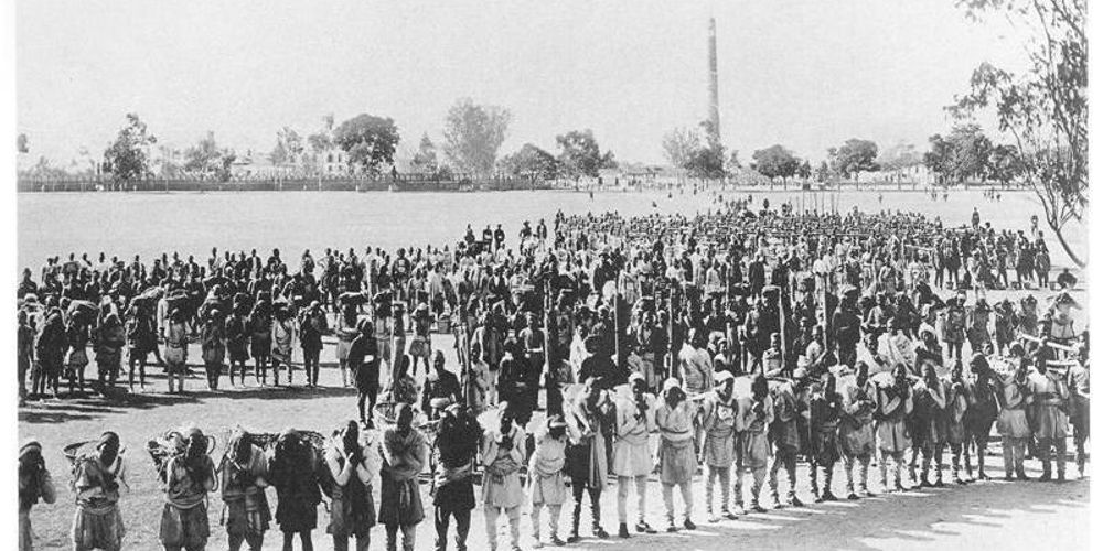 
            Tamang porters (Pipas) in the Gurkha Army stand in Tundikhel, Kathmandu, 1915. Though the Pipas were used by the Army to carry out menial work, they were left out of the military hierarchy. 