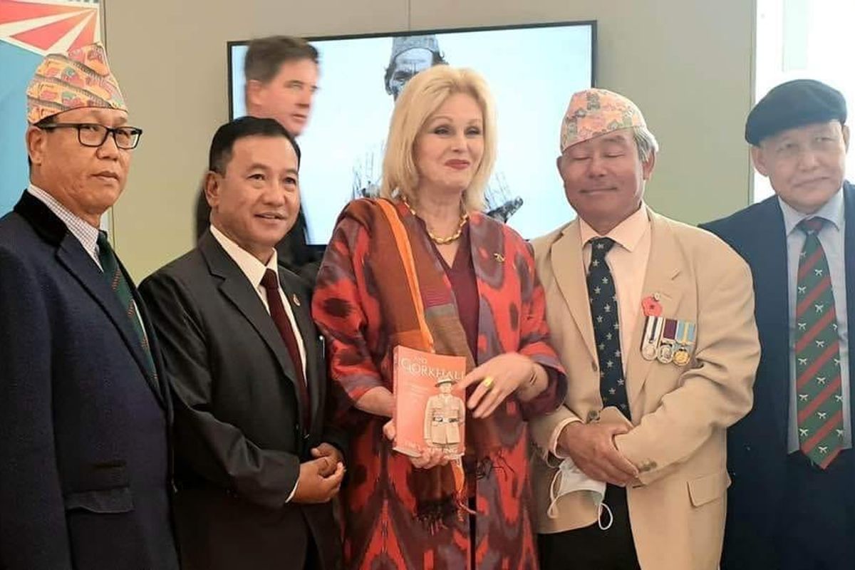
            British actor and Gurkha rights activist Joanna Lumley and Gurkha veterans with Tim Gurung's book, Ayo Gorkhali.