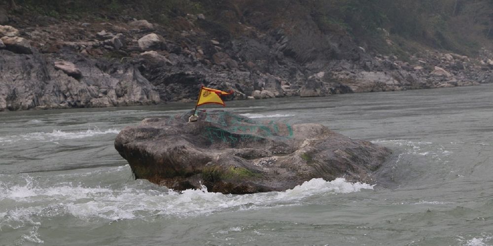 
            Khuwalung, a large rock in the Saptakoshi River, is a historical landmark for the Kirat community.